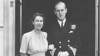 Prince Philip young - 11th July 1947: Princess Elizabeth and Lieutenant Philip Mountbatten outside Buckingham Palace after announcing their engagement publicly. (Photo by Topical Press Agency/Getty Images)
