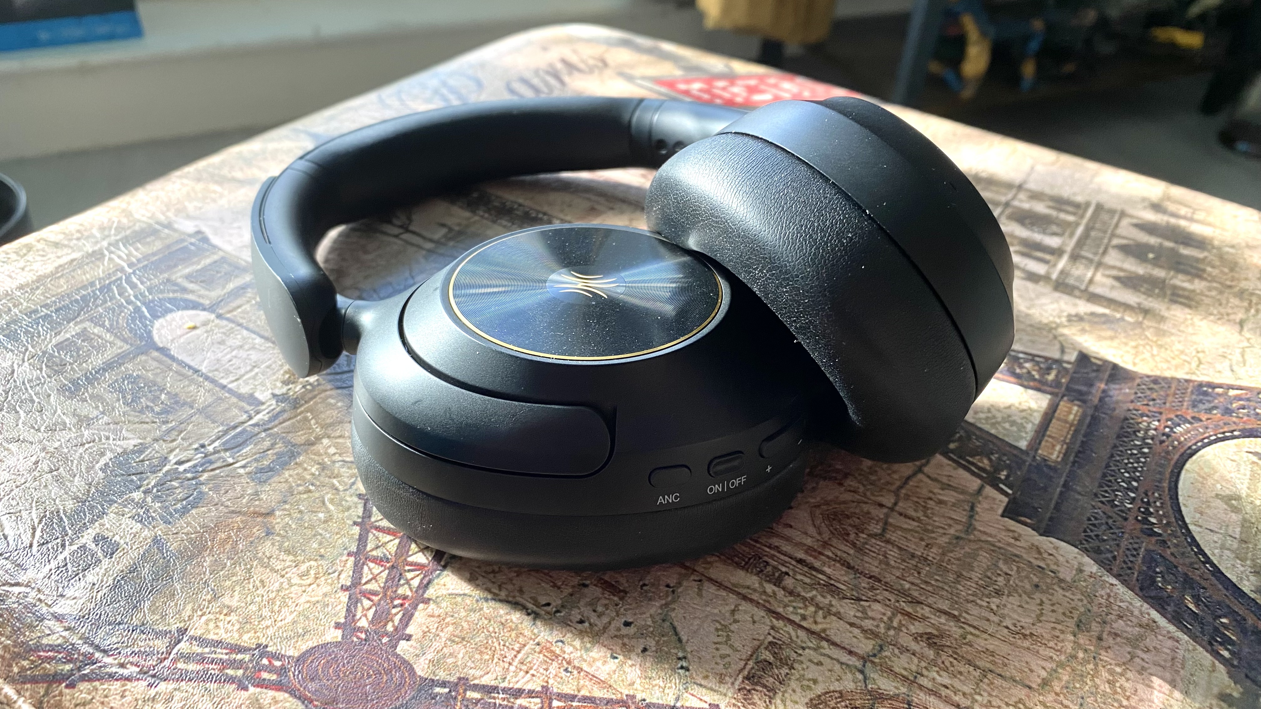 OneOdio Focus A6 over-ear headphones on a Parisian stool