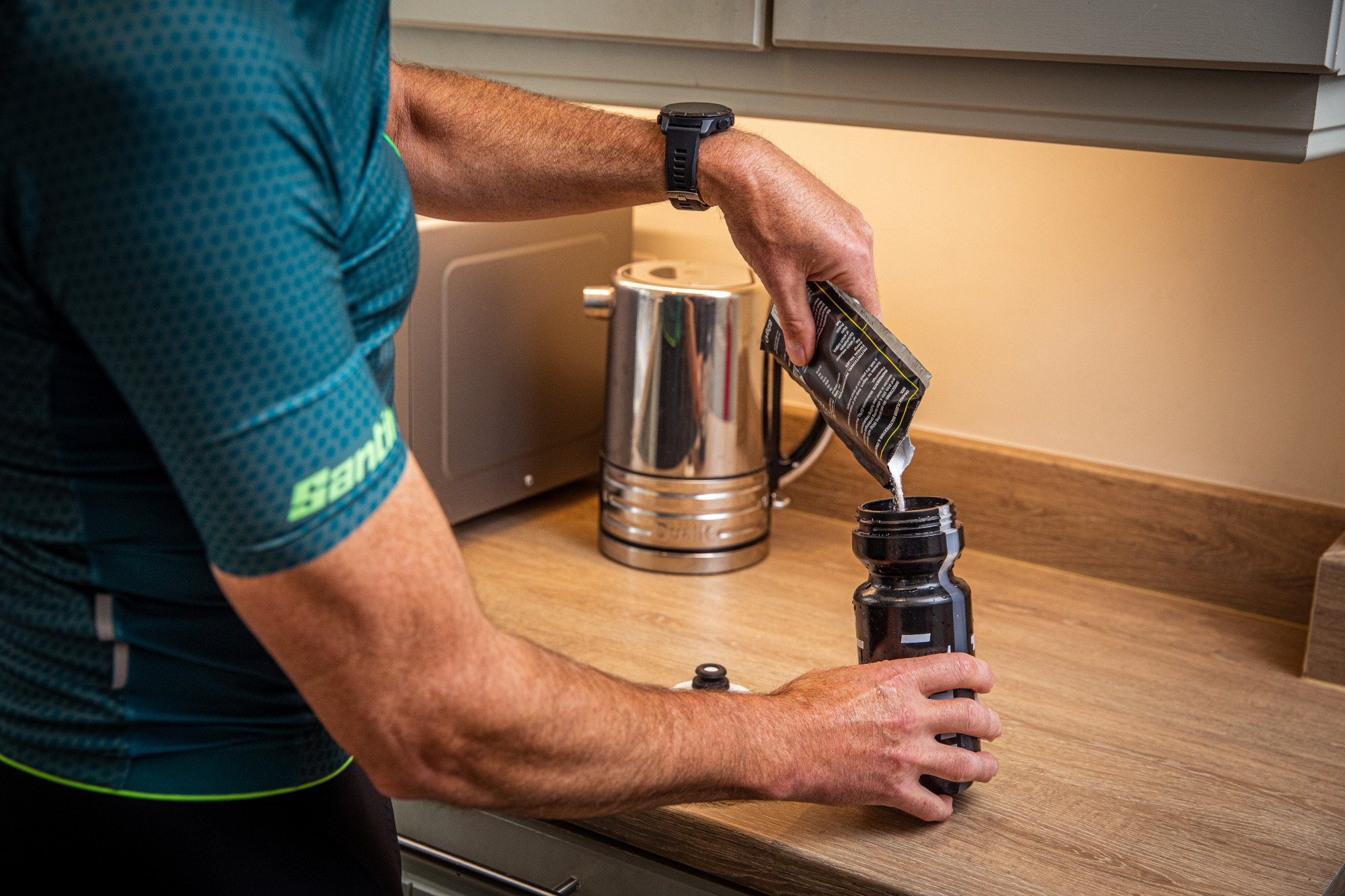 Image shows a rider drinking a protein-packed recovery drink.