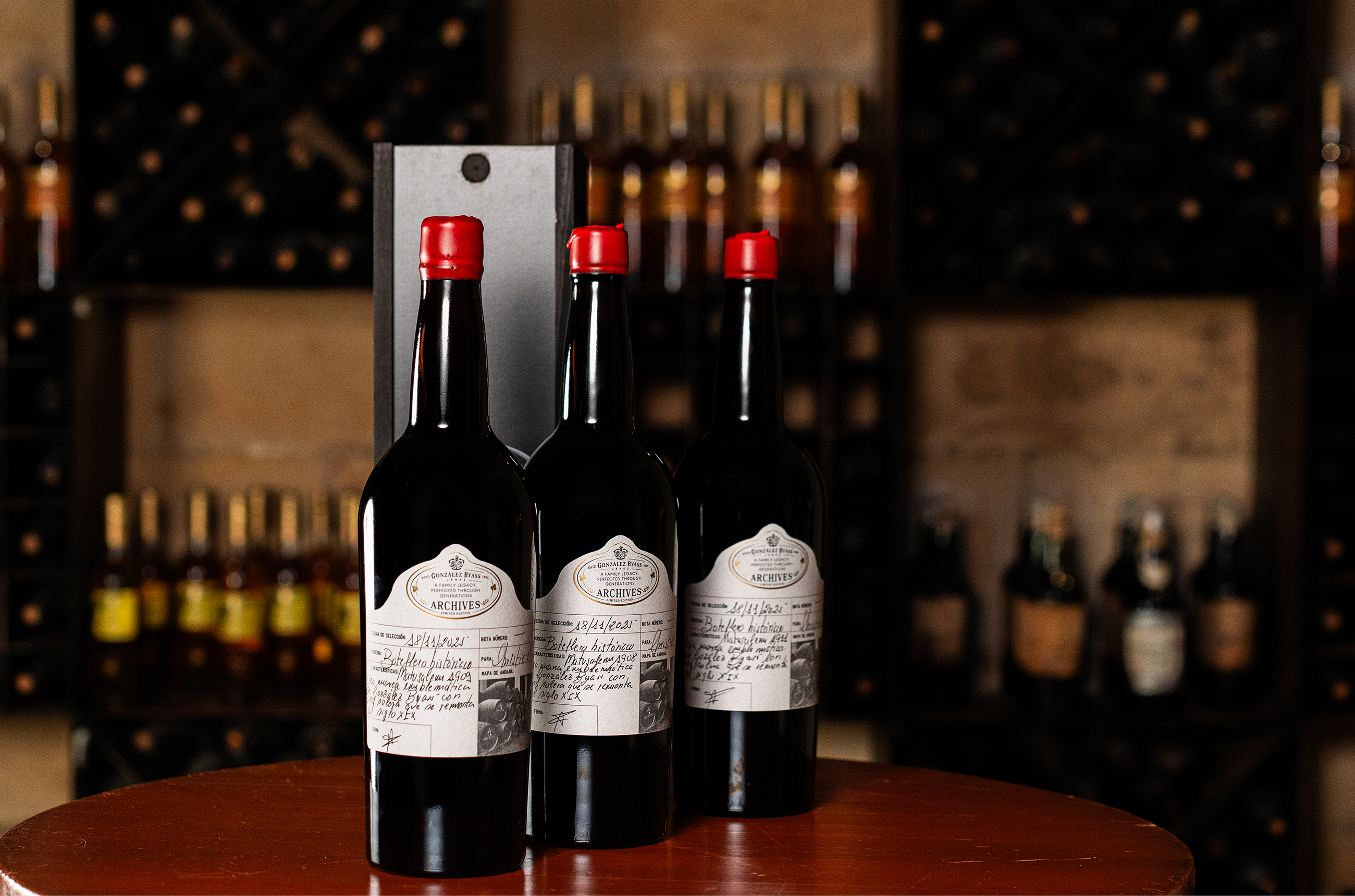 Three bottles of sherry with red wax lids and labels saying 'Archives'