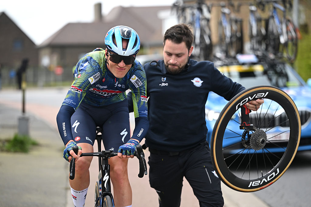 BRUGES, BELGIUM - MARCH 25: Dries Van Gestel of Belgium and Team Soudal Quick-Step assisted by the team car after being involved in a crash during the 50th Ronde Van Brugge - Tour of Bruges 2026 - Men&amp;amp;apos;s Elite a 202.9km one day race from Bruges to Bruges / #UCIWT / on March 25, 2026 in Bruges, Belgium. (Photo by Luc Claessen/Getty Images)