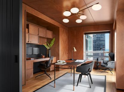 An all wood office with two tidy desks