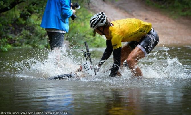 Race leader, Philip Buys, of SCOTT Factory Racing washes the mud off his bike during Stage 1