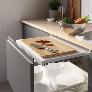 A kitchen countertop with a pull-out drawer for extra surface space