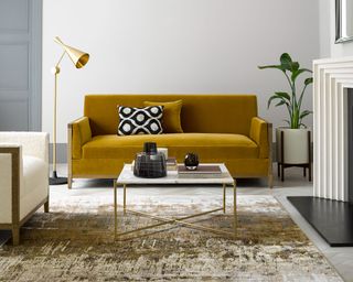 living room with yellow rug, artwork and rug, marble pieces, brass floor lamp, vases, armchair