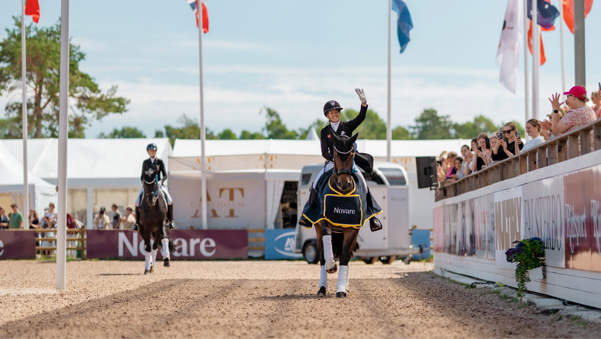 Cathrine Laudrup-Dufour riding Mount St John Freestyle waving to the crowd during the lap of honour after their freestyle win at Falsterbo Horse Show.