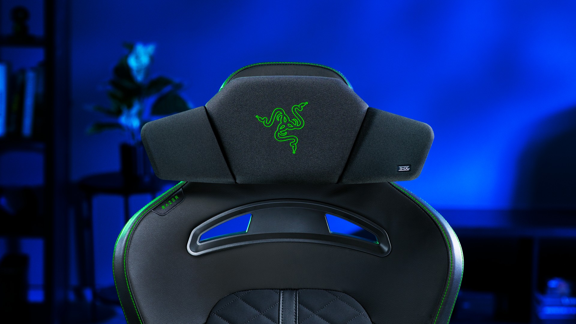 Razer Clio headrest speaker on a gaming chair in a blue setup