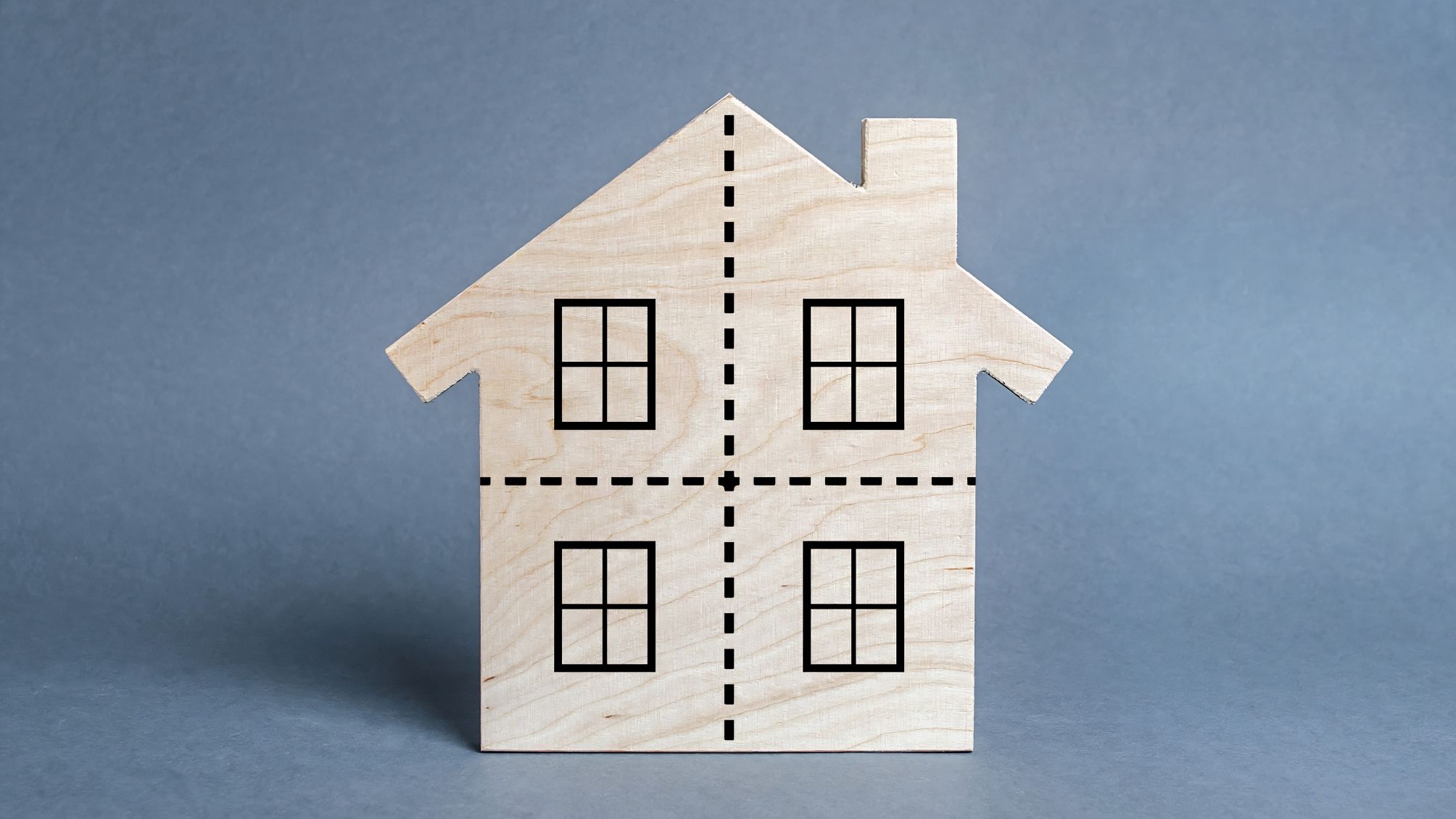 A model house with dotted lines on the front. 