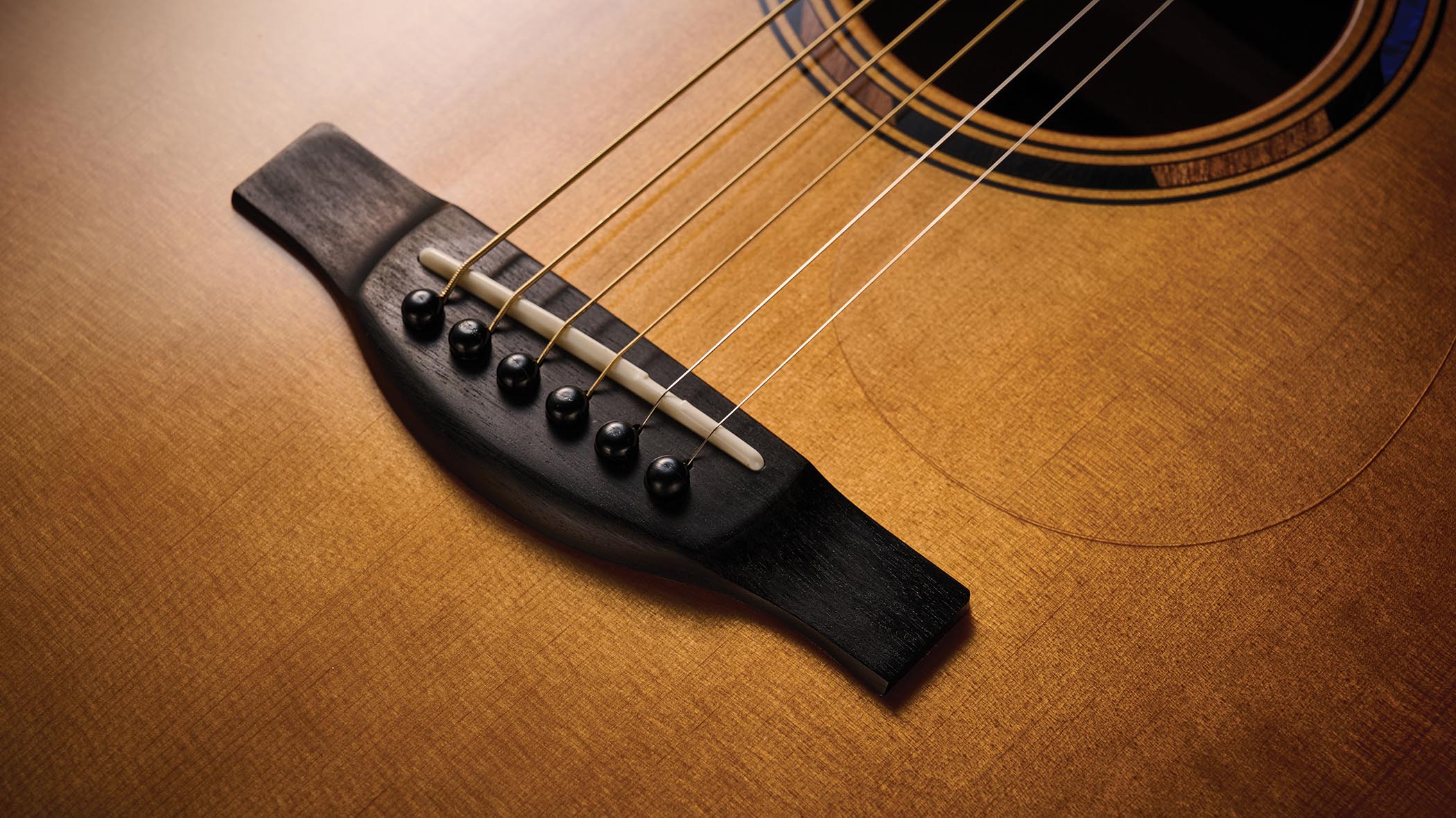 The Yamaha TransAcoustic TAG3 C is a cutaway acoustic guitar with a sandburst finished, photographed in closeup