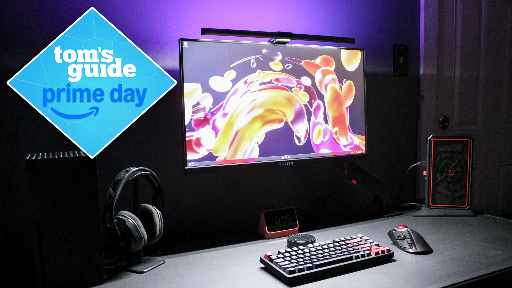 A desk setup with the Quntis RGB Pro+ Monitor Light Bar on top with a Tom&#039;s Guide Prime Day deals badge