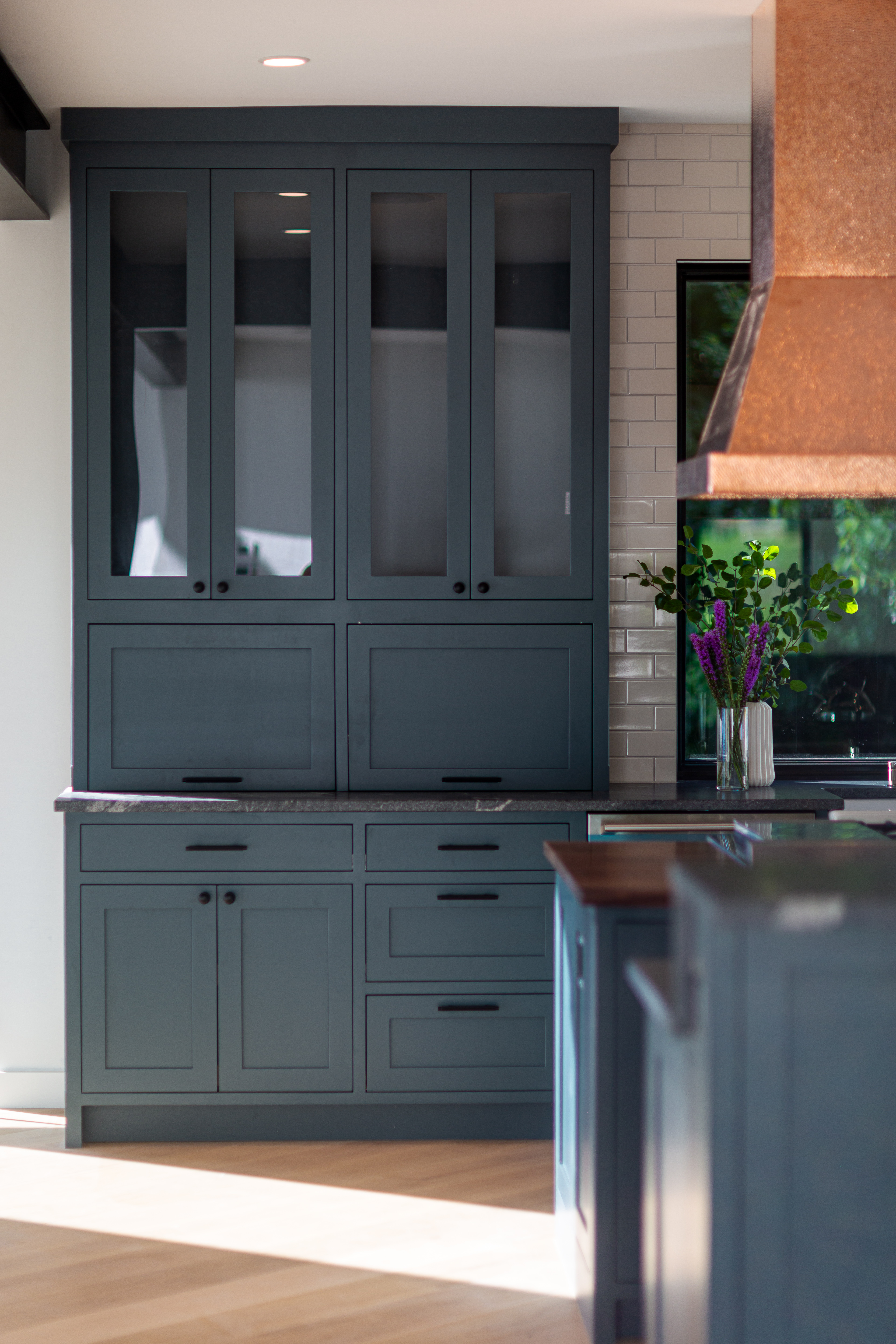Pale blue-painted kitchen cabinet.