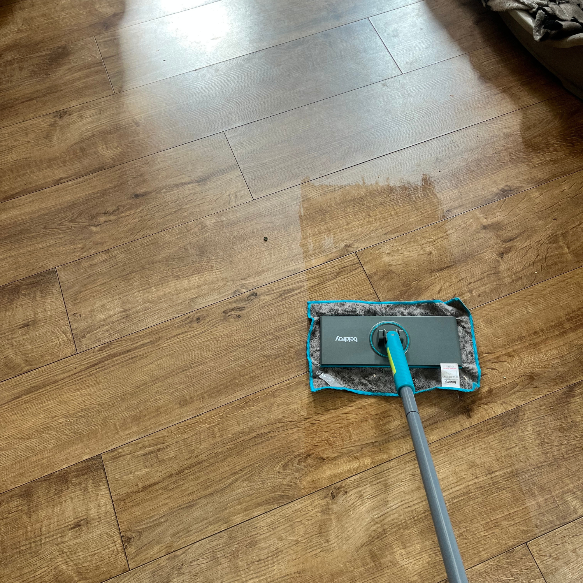 The Beldray clip-to-grip mop in action on a wooden floor.