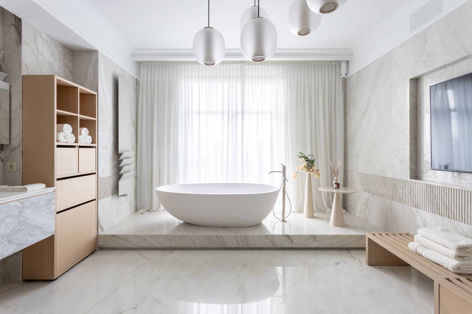 A bathroom with floor to ceiling curtains