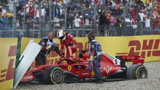 Sebastian Vettel climbs from his Ferrari after crashing out of the 2018 F1 German Grand Prix