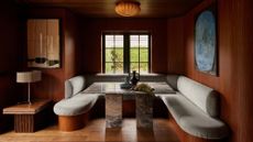 dining room nook with wooden walls and flooring and a marble dining table