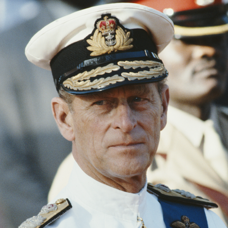 Prince Philip wears white naval uniform and looks stern
