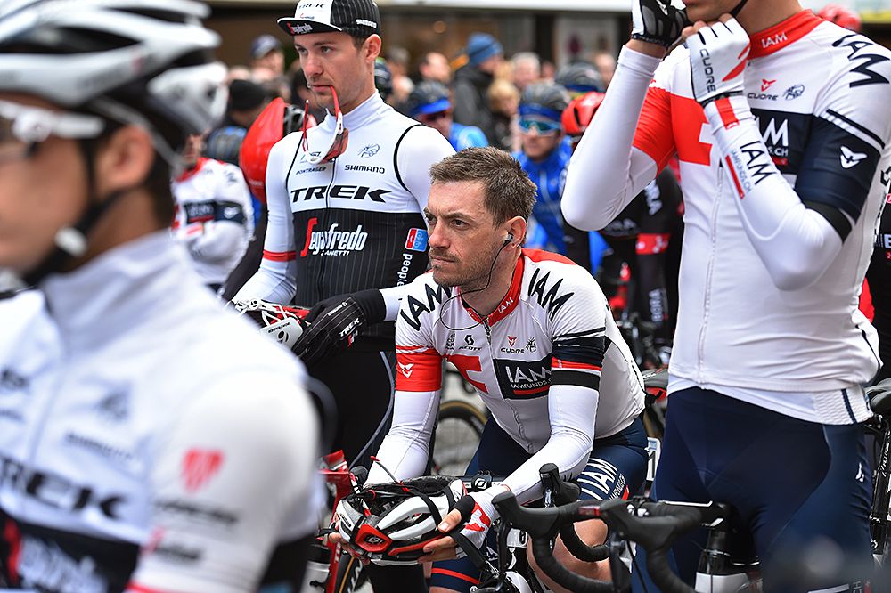 Riders take a moment of silence for the mourning of the terrorist attacks in Brussels before the start of Dwars door Vlaanderen