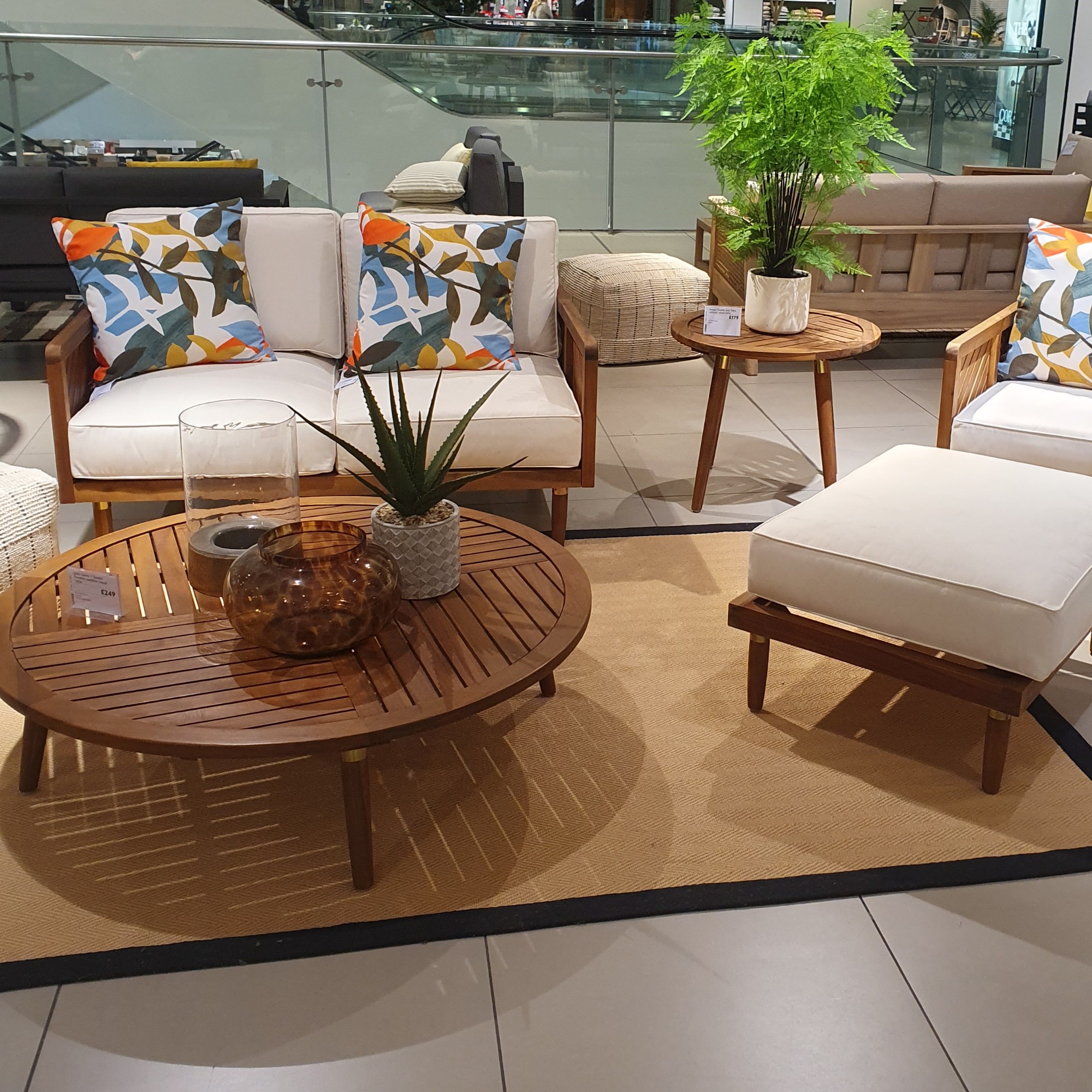 The John Lewis x Swoon Franklin outdoor lounge set made from acacia wood displayed in the John Lewis Oxford Street store