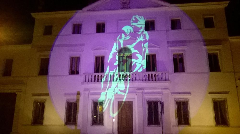 A projection in pink on the Palazzo Menegozzi in Aviano