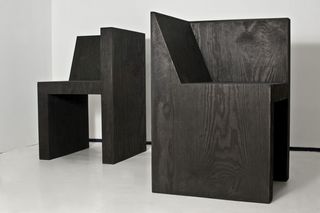 Minimalist black chairs constructed of black plywood and alabaster
