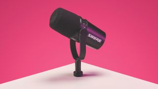 A Shure MV7 balancing on the edge of a table