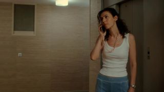 Géraldine Nakache as Detective Sara Roussel looking worried while speaking on the phone in a scene from The Disappearance of Kimmy Diore.