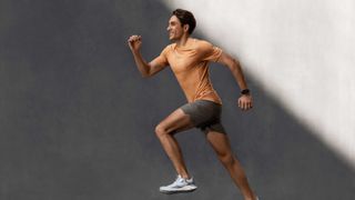 Person running in shorts and t-shirt wearing the watch