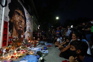 Fans hold a vigil for Diego Maradona outside the stadium of Argentinos Juniors
