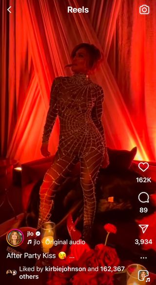 A still of Jennifer Lopez showing off her curves in a sheer Zuhair Murad crystal cobweb catsuit.