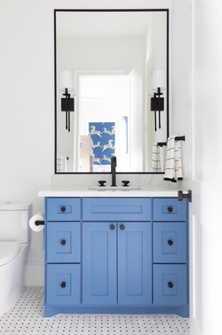 A bathroom with bright blue vanity