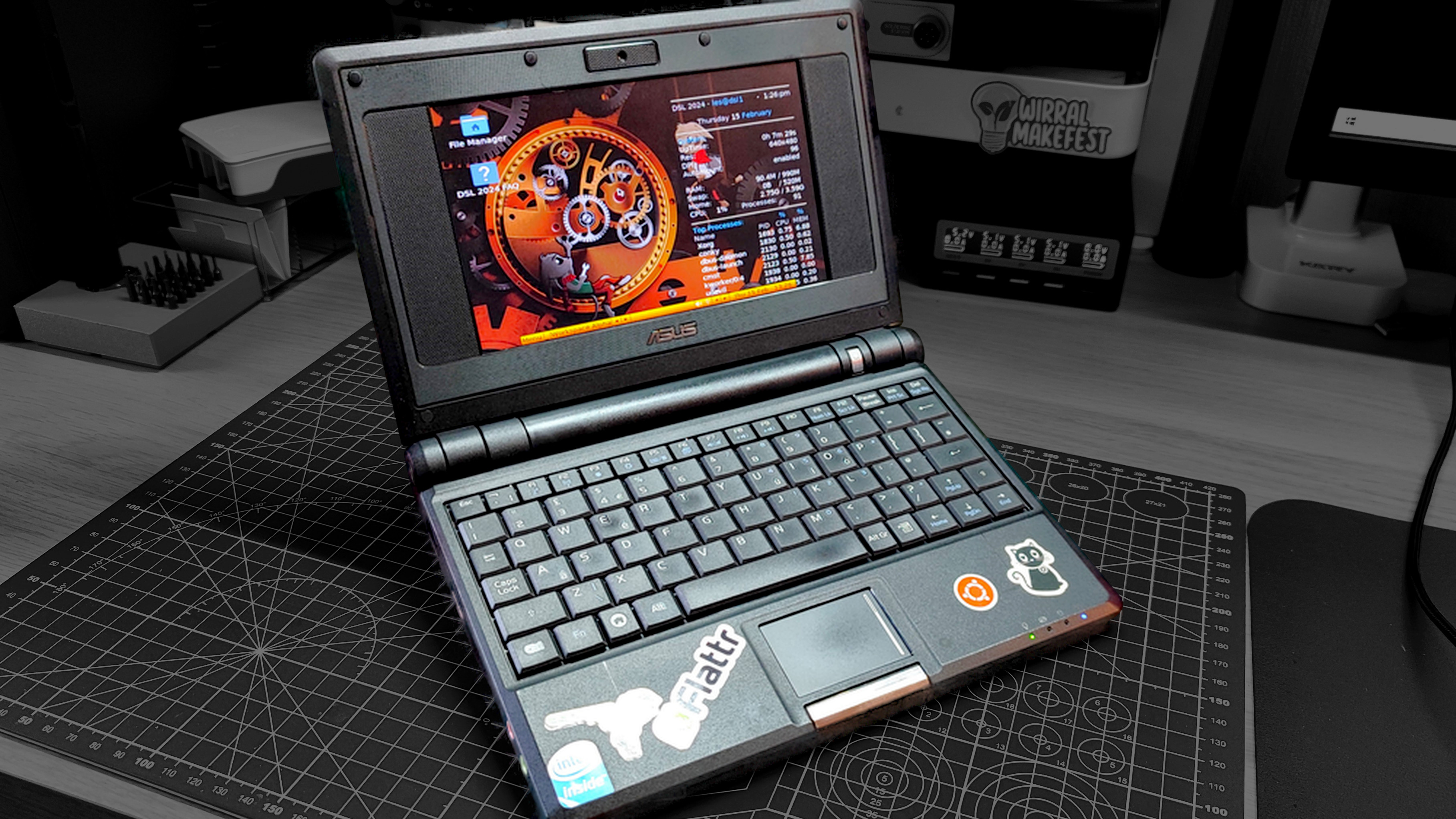 An Asus eee PC on a dark, grayscale background.