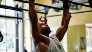 A man performing pull ups at the gym