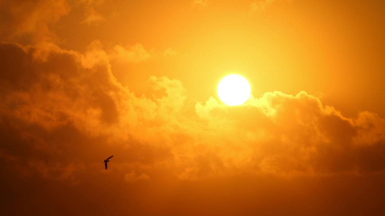 The sun peaking out from a cloud