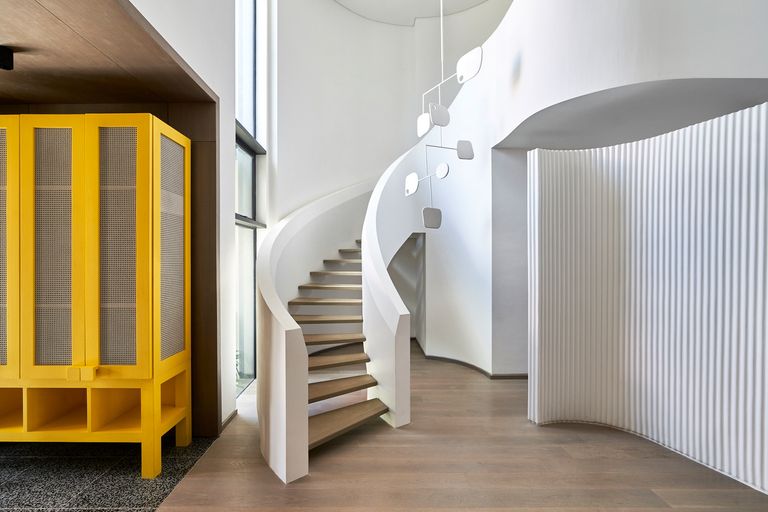 white staircase with yellow cupboard