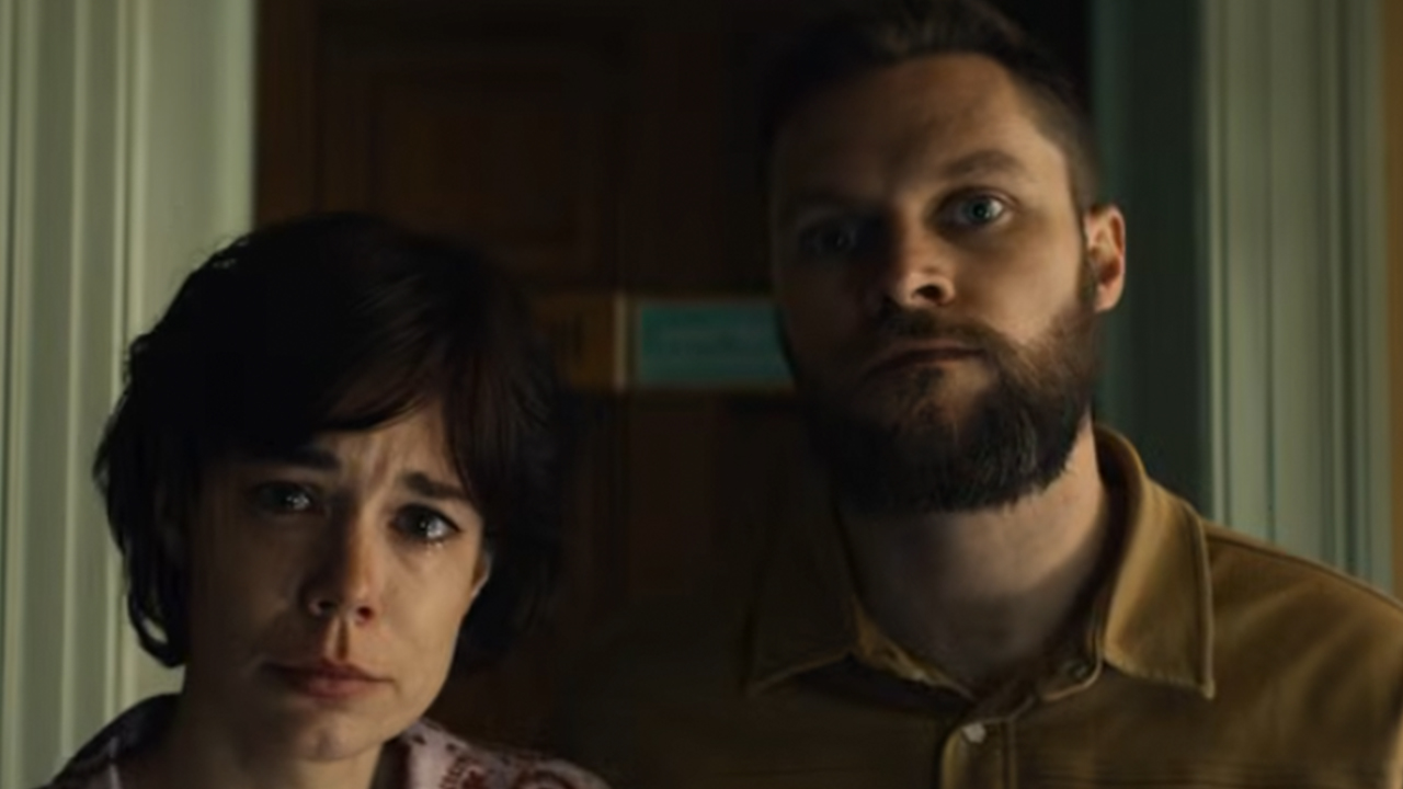 A woman and a man looking into the camera in Lee Cronin's The Mummy