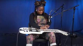 Yasmin Williams lap-tapping on a Gibson double-neck