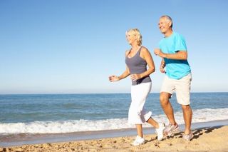 older-couple-running-beach-11072102