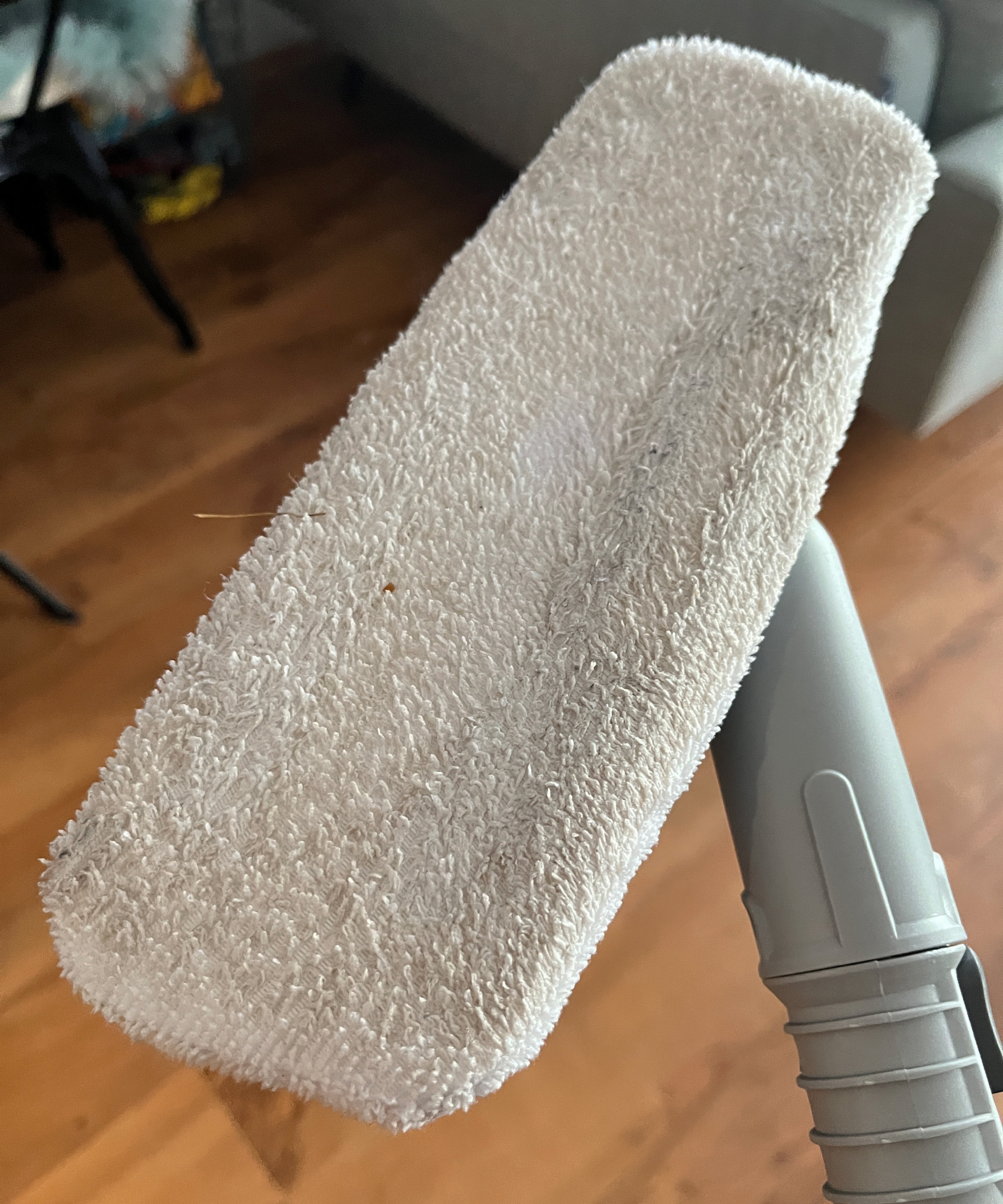 dirty white mop head on steam cleaner attachment