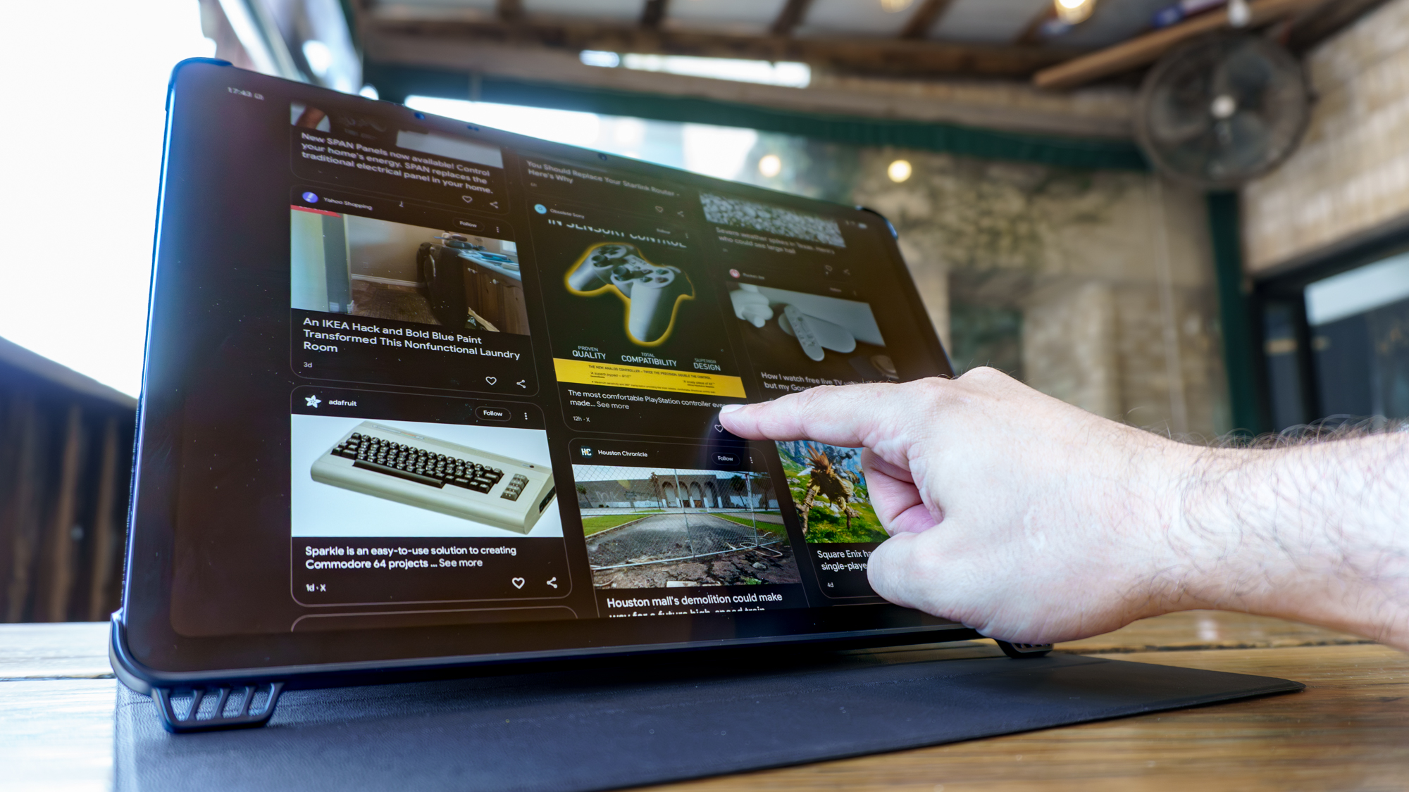 A person scrolling through Google Discover on the TCL NXTPAPER 14