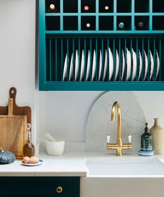 colors that got with teal, teal and white kitchen, teal cabinets, teal wall mounted wine store, white countertops, brass twin tap