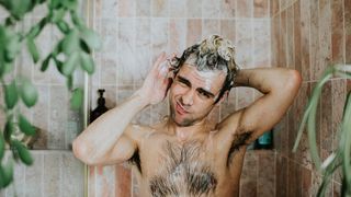 Portrait of a man washing his hair in the shower