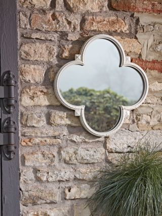 small mirror from Cox & Cox on brick wall