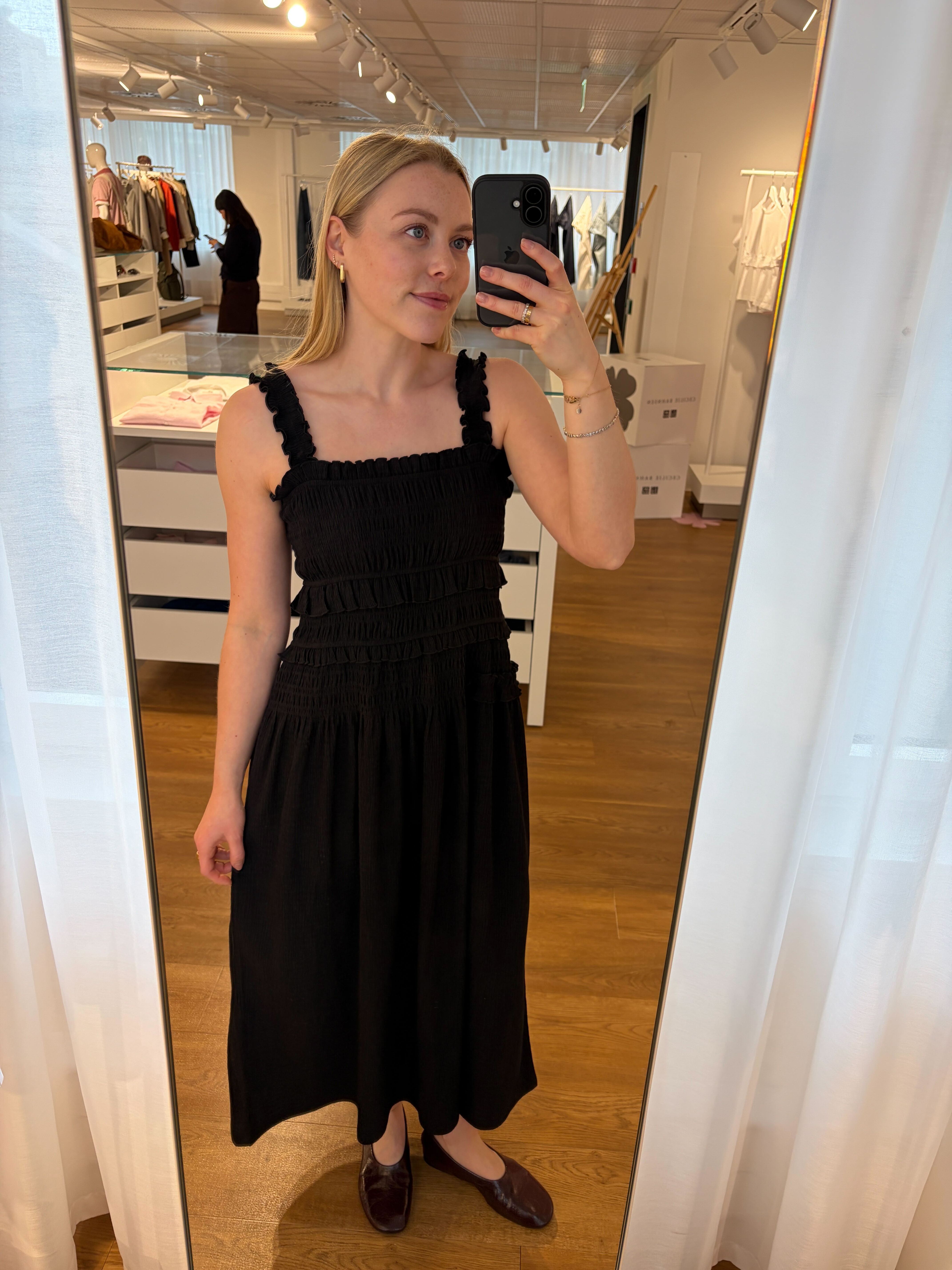 flory is wearing a black dress