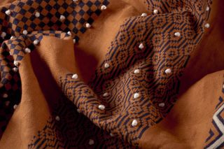 rust fabric with black and white paterning