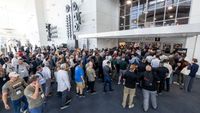 A swarm of attendees rush the CEDIA Expo as doors open.