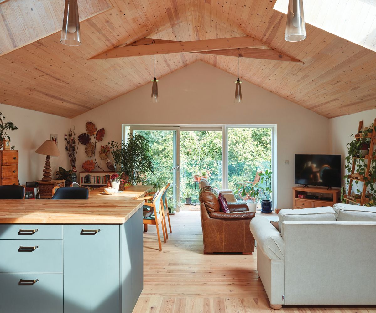 inside view of open plan living area with vaulted light wooden ceiling and floor