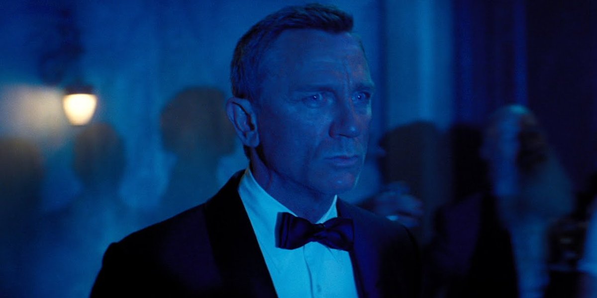 Daniel Craig looks concerned while bathed in blue light in No Time To Die.