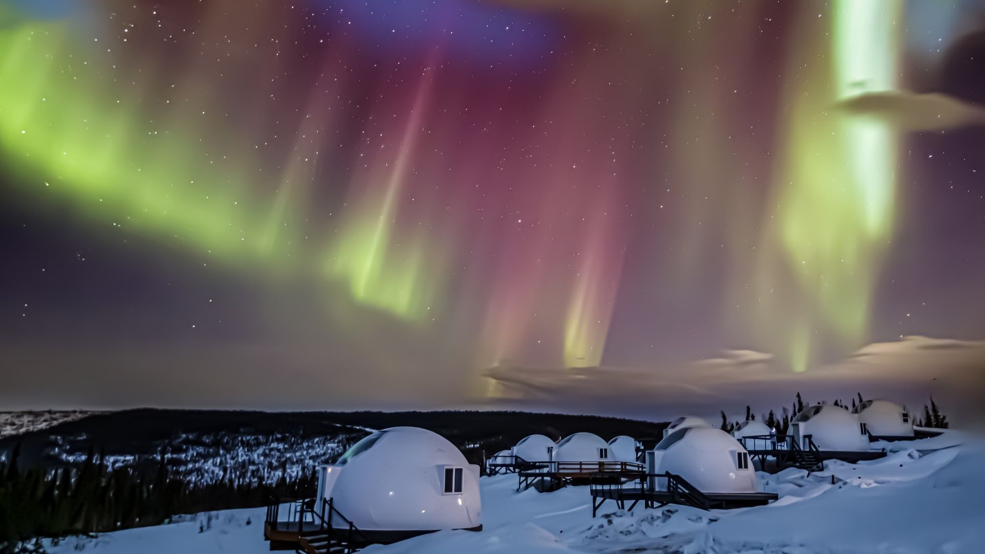 auroras dance in the sky above white spherical 
