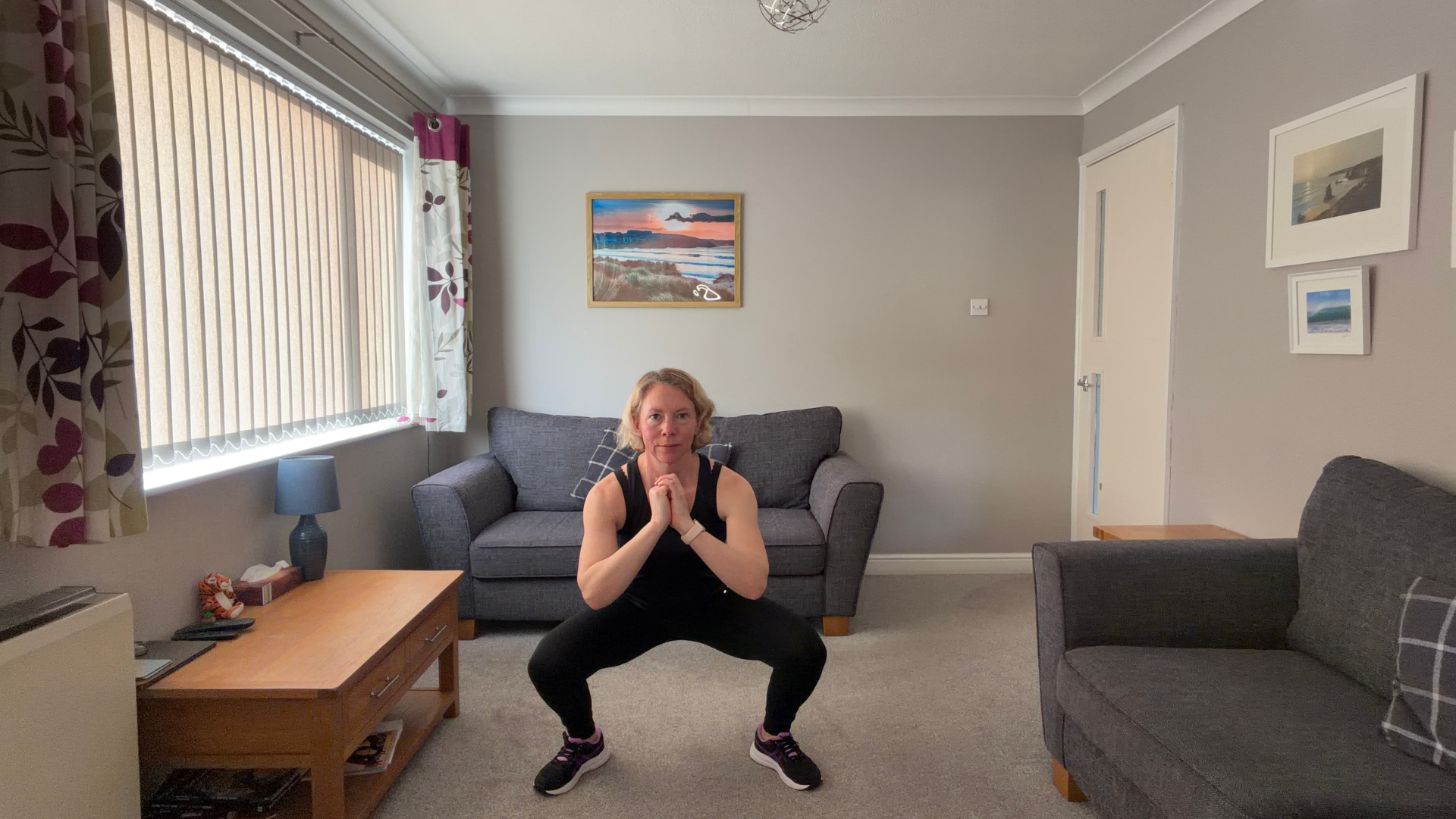 Personal trainer Becky Fuller performing stretching demonstrations in a living room