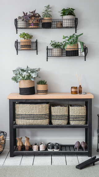 wooden console table in a hallway with shoe storage